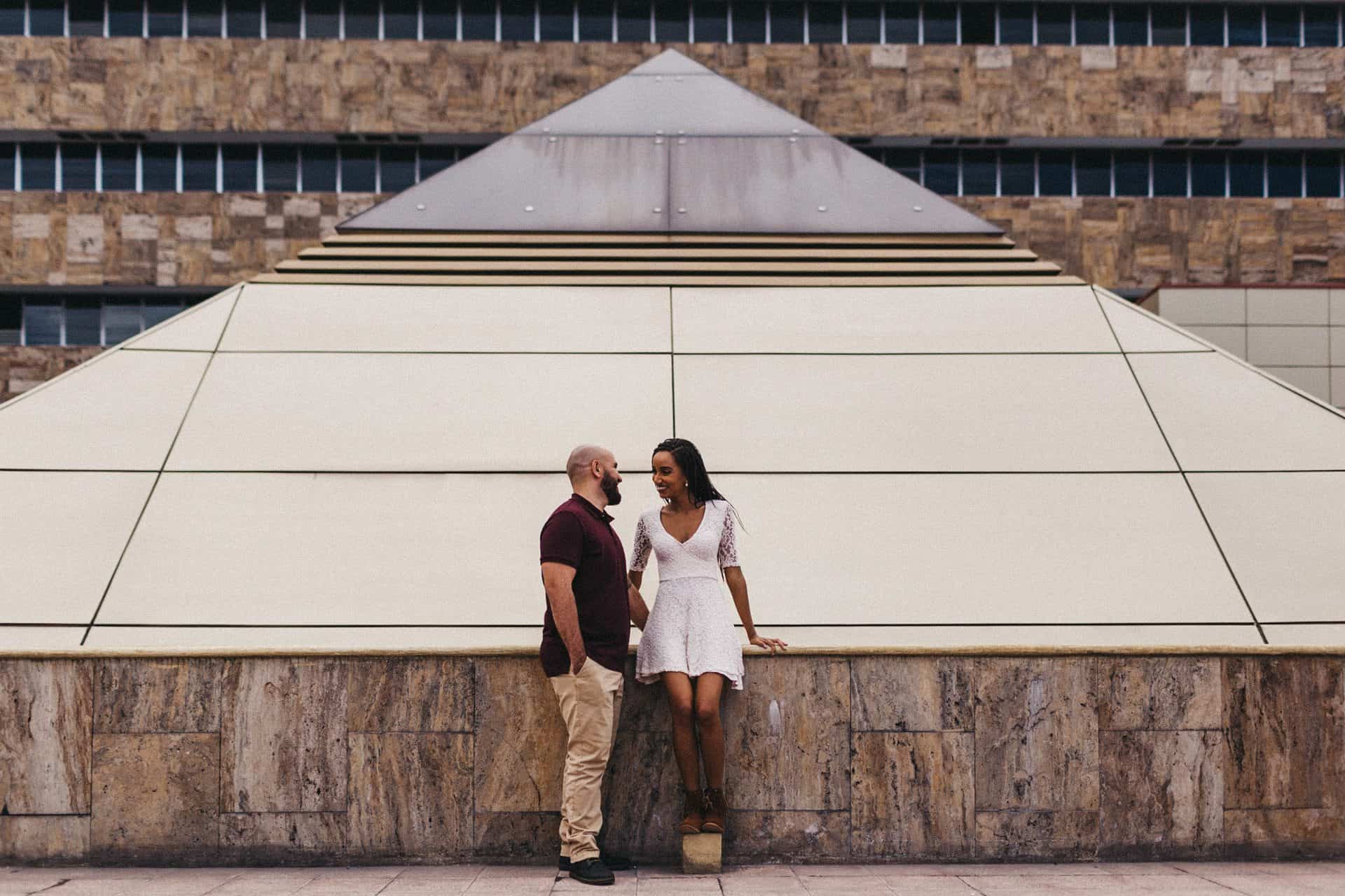 Couple dancing together on a quiet street in Costa Rica during their engagement session, captured in warm, golden afternoon light.