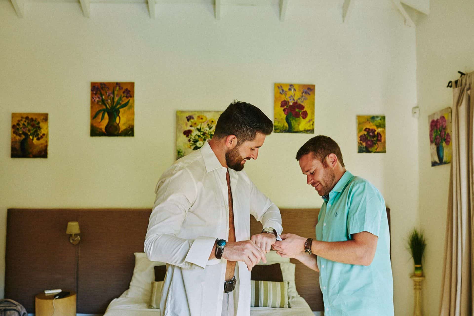 groom getting ready for beach wedding in costa rica