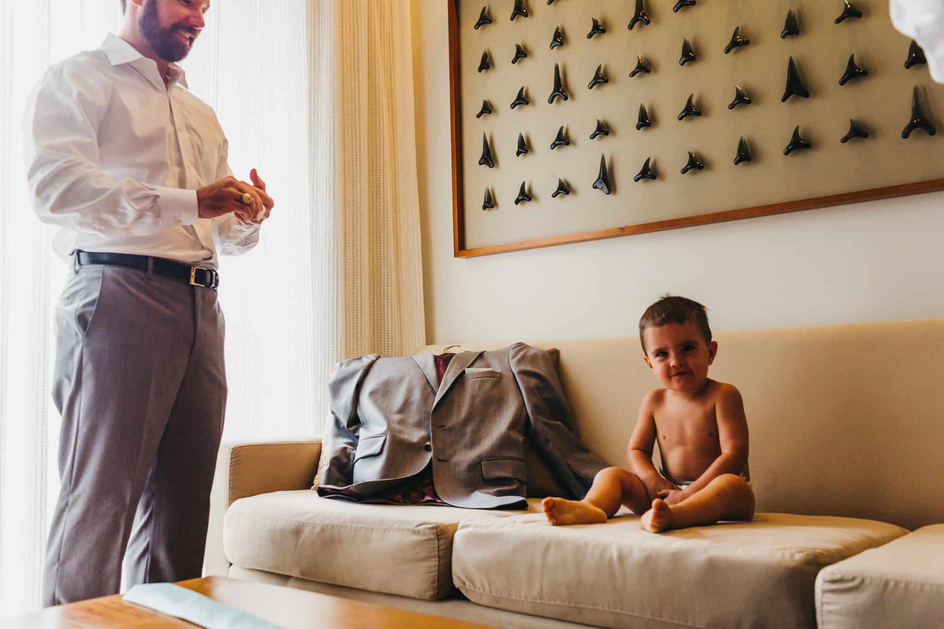 Groom getting ready with his nephew at beach wedding at El Mangroove hotel in papagayo costa rica