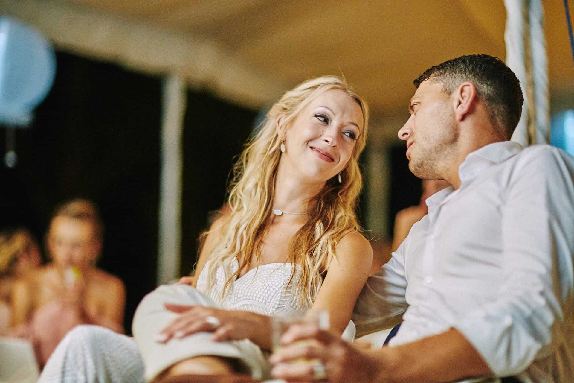 Couple smiling to each other during toast at beach wedding in costa rica
