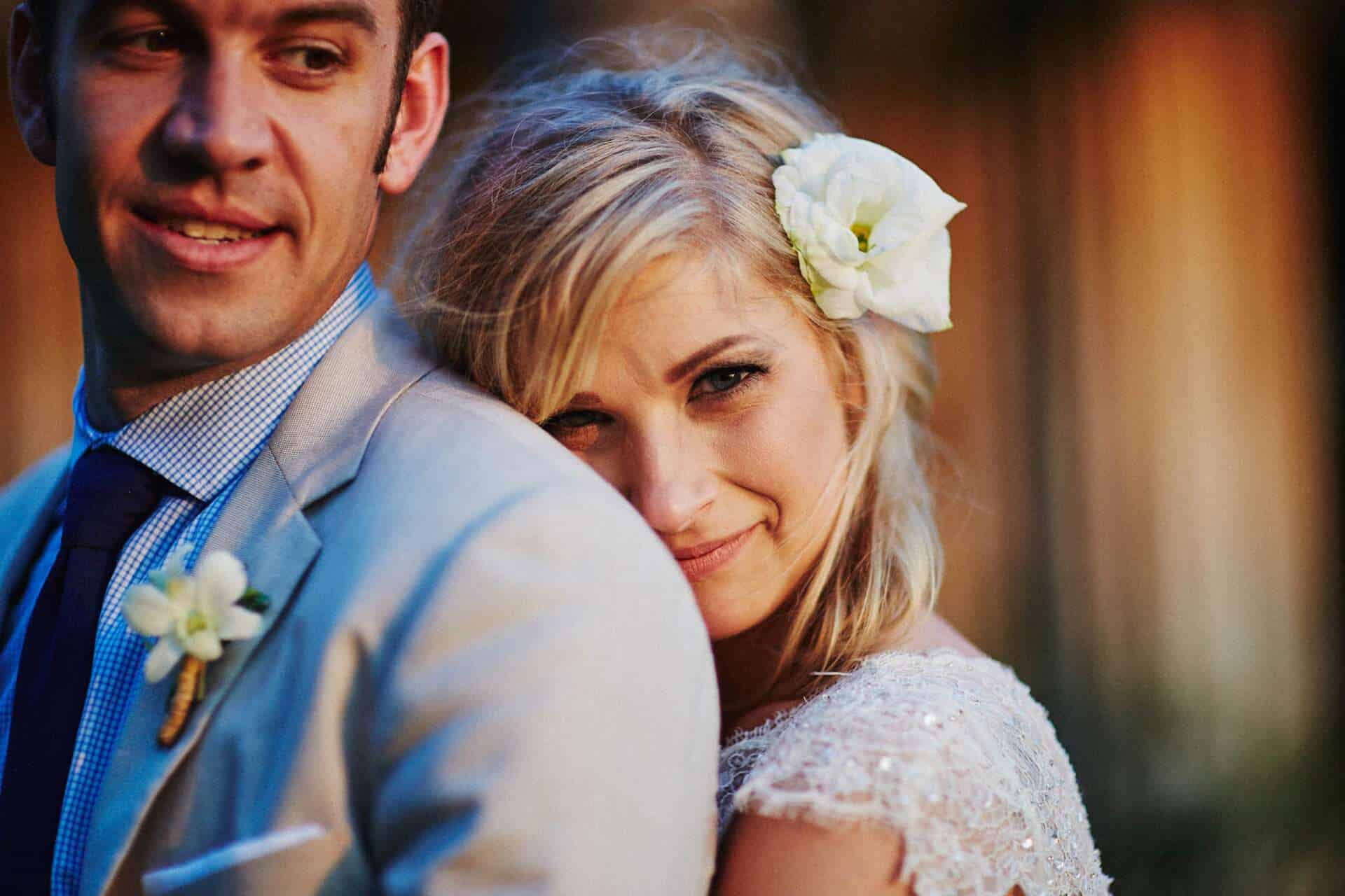 Bride smiling while embracing her groom during sunset after their destination wedding in Costa Rica.