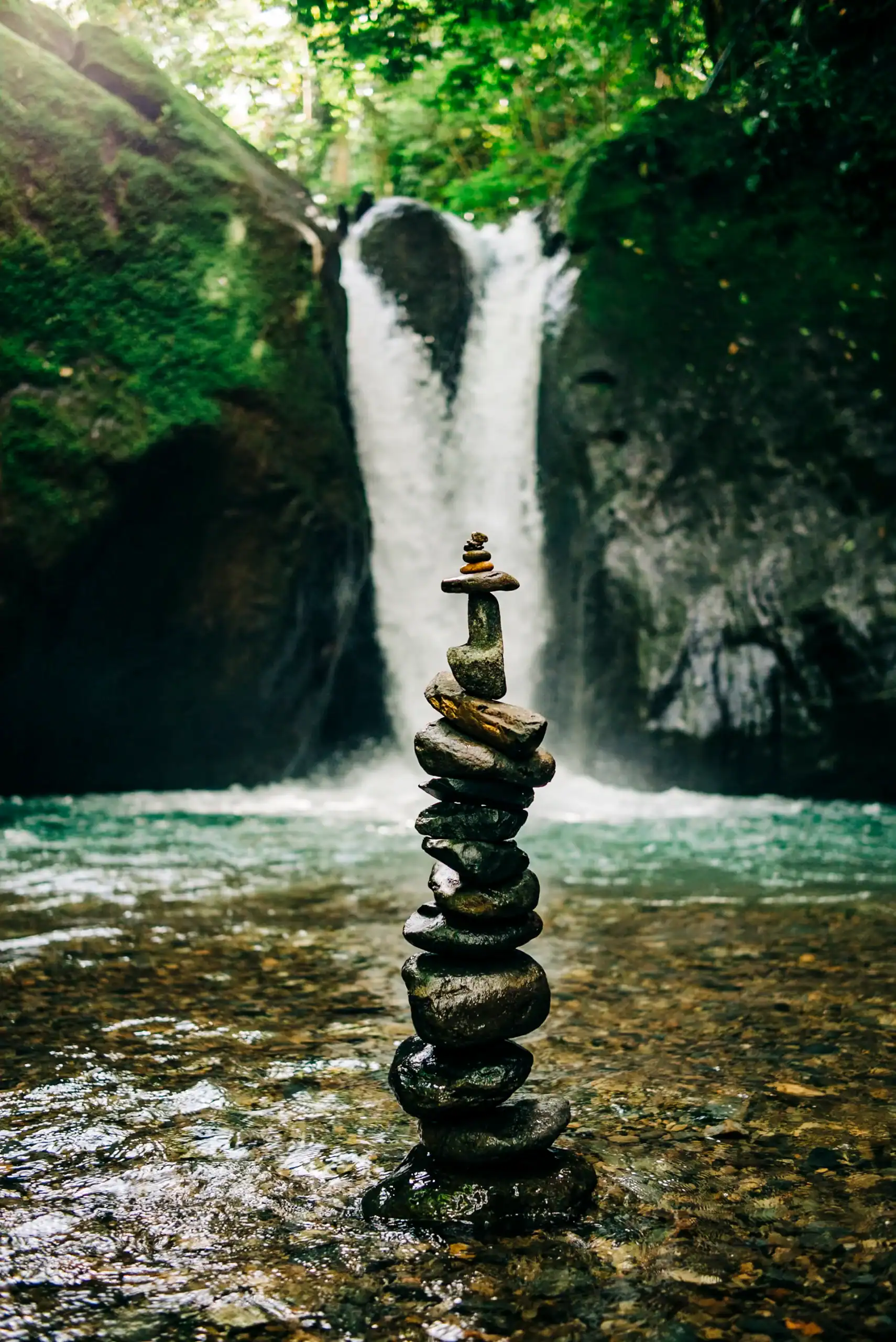 a stack of rocks in front of a waterfall engagement session weddings costa rica