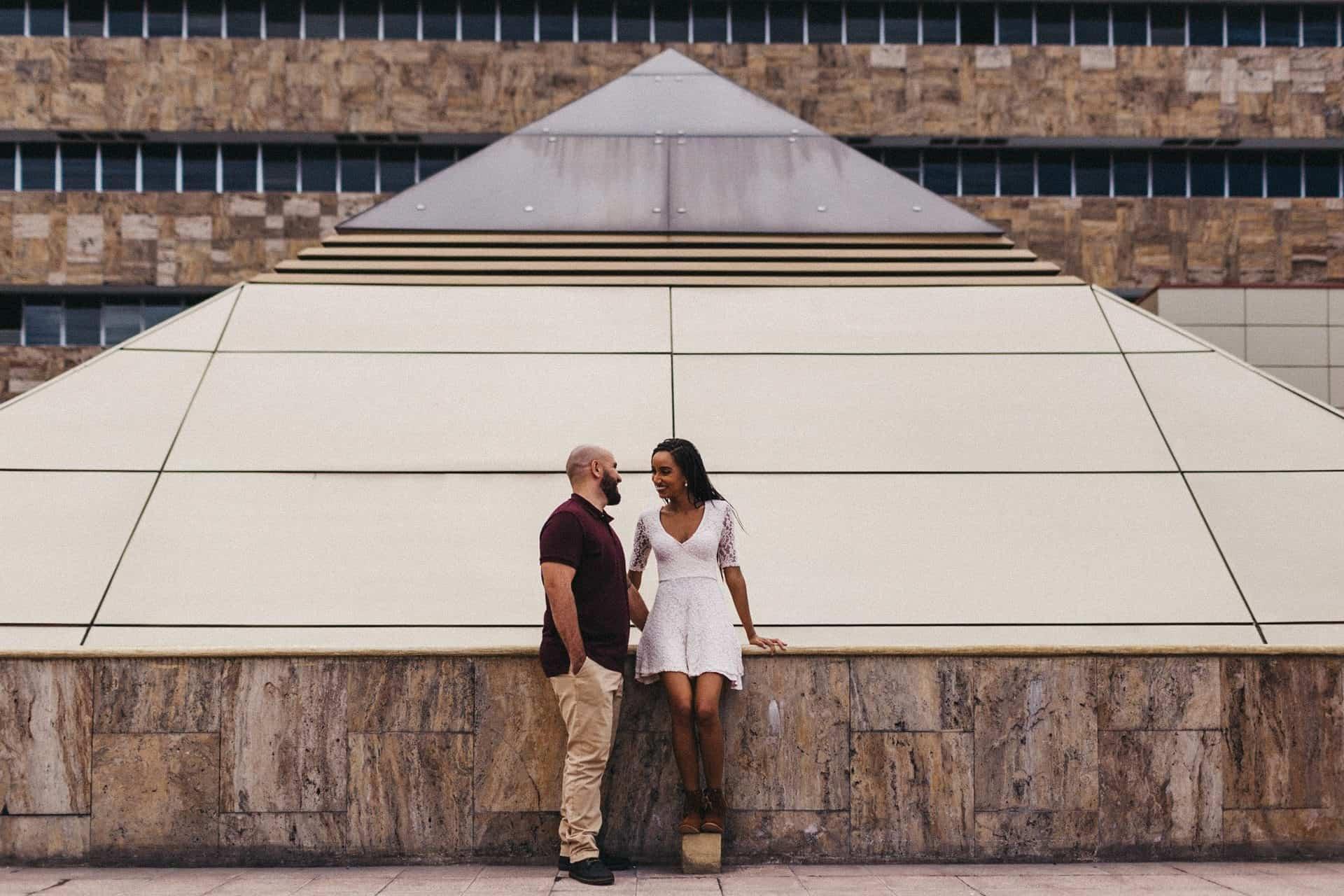 Couple dancing together on a quiet street in Costa Rica during their engagement session, captured in warm, golden afternoon light.