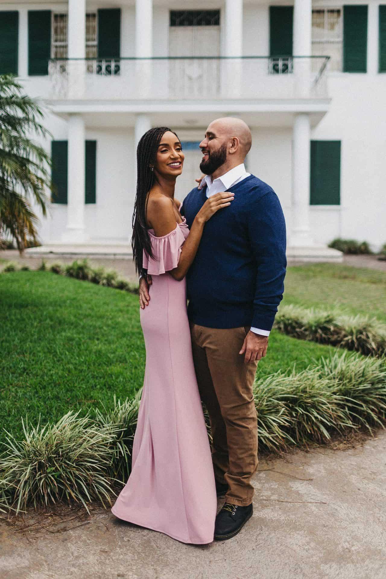 Candid moment of a couple walking hand in hand on a cobblestone street during their engagement session in Costa Rica
