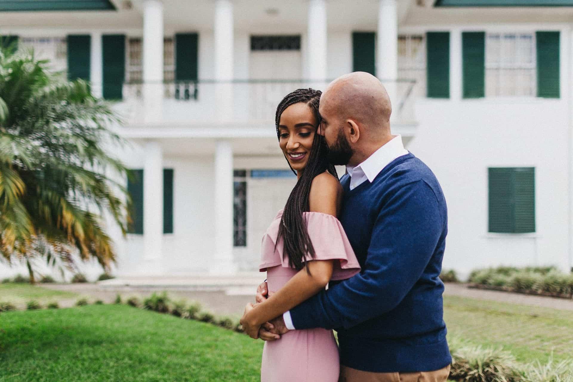 Candid moment of a couple walking hand in hand on a cobblestone street during their engagement session in Costa Rica