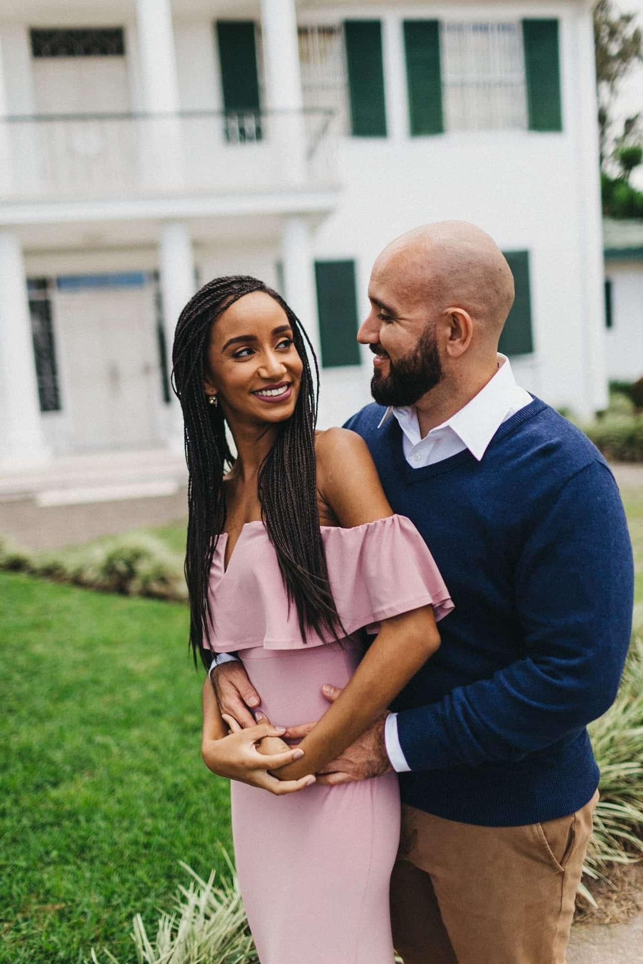 Candid moment of a couple walking hand in hand on a cobblestone street during their engagement session in Costa Rica