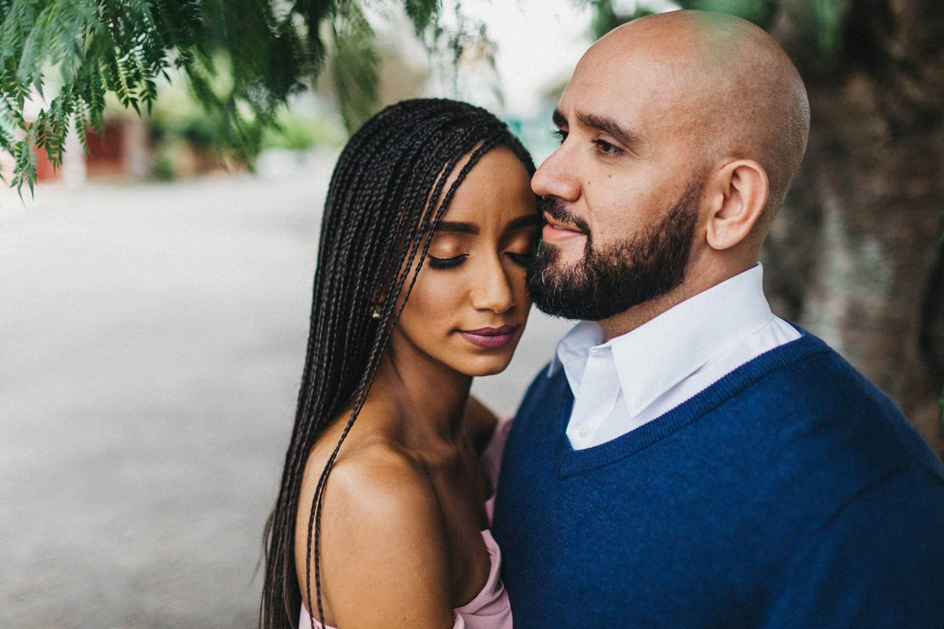 Close-up of a couple smiling and holding hands during a Costa Rica engagement session, highlighting their love story.