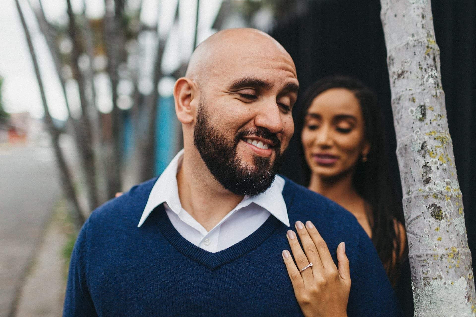 Close-up of a couple smiling and holding hands during a Costa Rica engagement session, highlighting their love story.