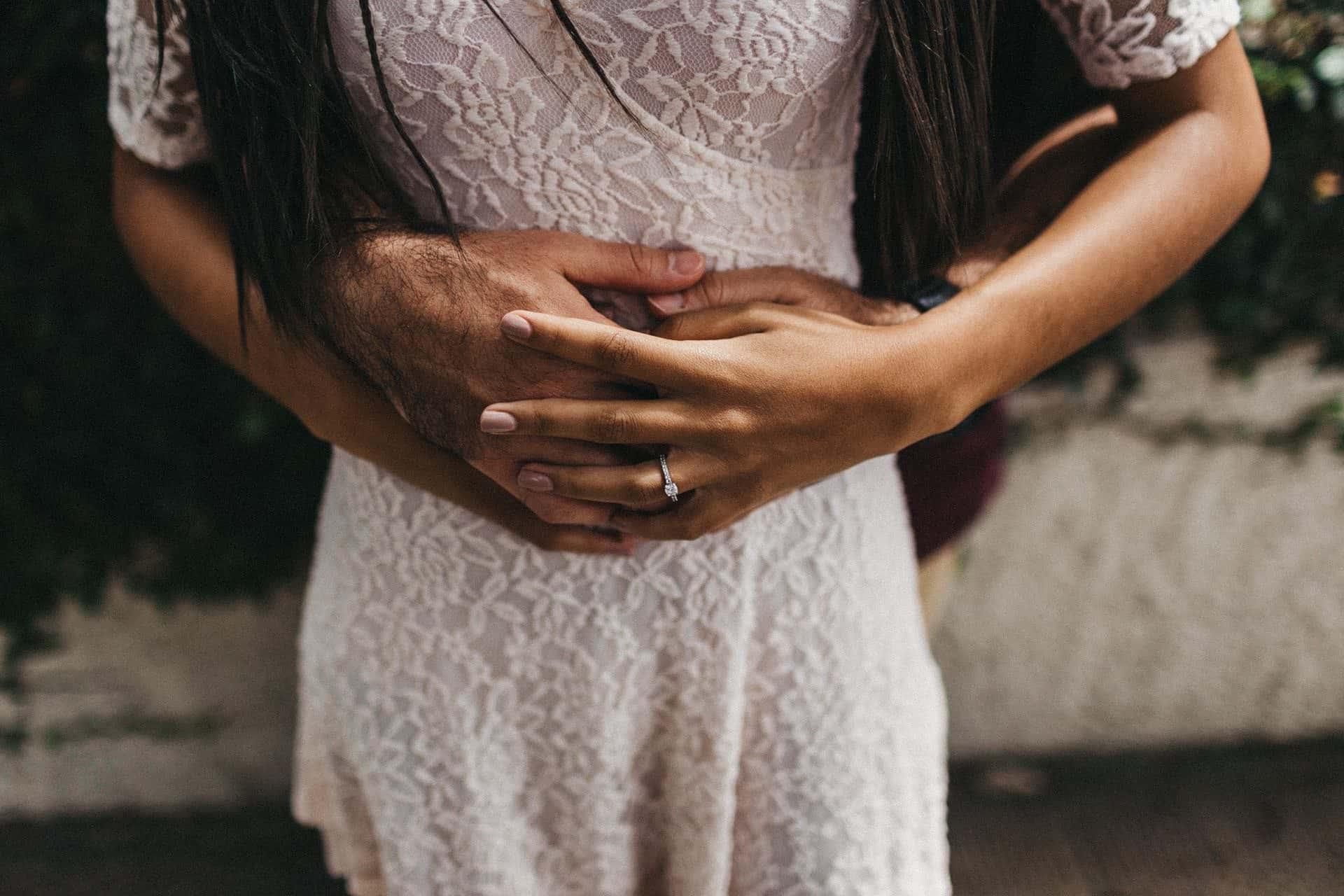 Couple enjoying a romantic engagement session in a historic neighborhood of San José, Costa Rica, surrounded by colorful colonial architecture